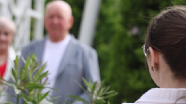 Close up of a photographer camera flash with blurred senior guests in background