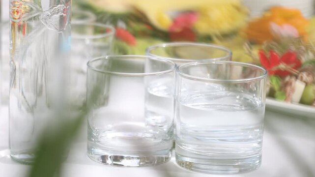 Selective focus on glass tumblers with pure still water at a restaurant celebration table