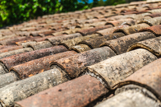 Close up of aged terracotta roof tiles on traditional medieval house in Rupit, Catalonia, Spain