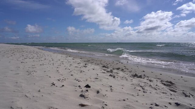 Empty Sandy Beach with Pebbles and Rolling Waves at Grenen, Skagen, Denmark