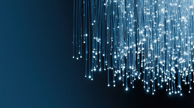 Glowing strands of light descend against a deep blue, dark background