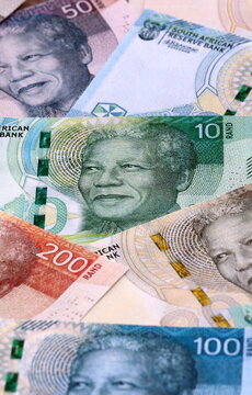 South African rand money bills pile on table. South Africa banknotes of ZAR currency close up.