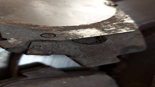 Macro close up of the back side of a used car brake pad with shim