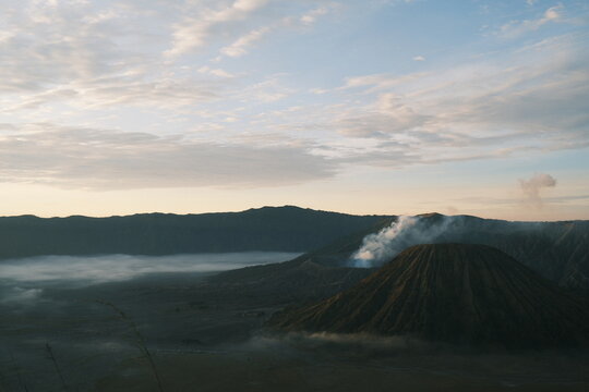 Mount Bromo Volcano at Sunrise with Mist and Smoke Plume