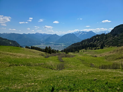 Austria, Spectacular valley panorama overlooking Reutte city beyond green meadows forests and endless alpine mountains from hahnenkamm