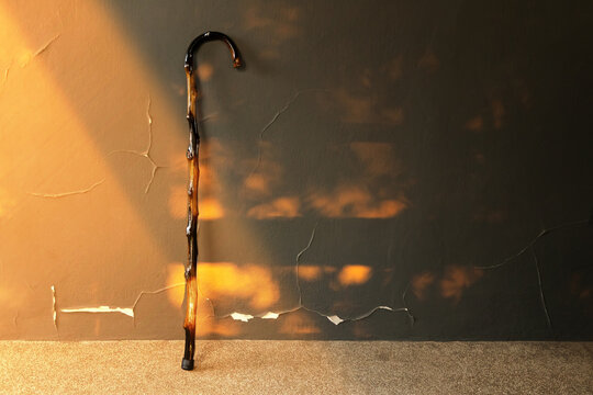Old walking cane standing alone , aging society, loneliness, elderly life and social care