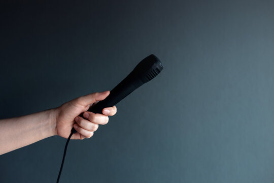 Hand holding microphone, freedom of speech, communication, interview and public speaking