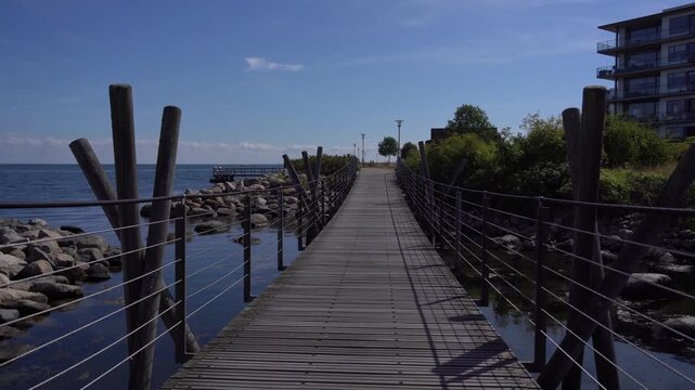 Wooden Boardwalk Along Copenhagen Coastal Promenade with Sea View, Denmark
