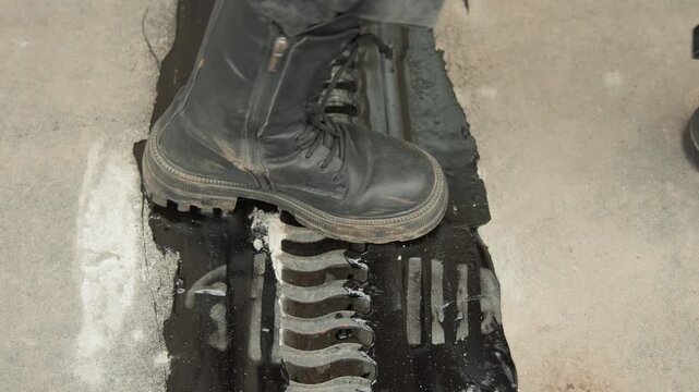 Contractor tests pavement durability. Sealant around expansion joint verified for safety. Inspection confirms how well sealed expansion joint maintains strength and grip under wet conditions