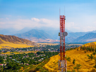 Obraz premium Communication Tower Overlooking Town in Kyrgyzstan