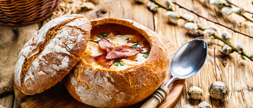 Traditional Polish Żurek Soup Served in Bread Bowl with Sausage and Eggs. AI generative.