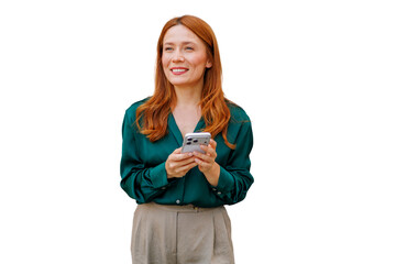 Smiling woman with ginger hair using a smartphone, texting or browsing content, looking to the...