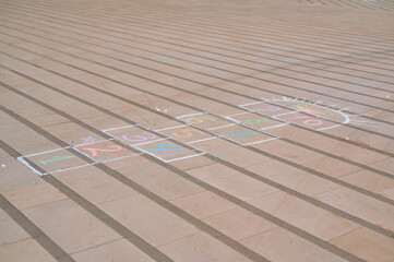 Fototapeta premium Colorful Hopscotch Game Drawn with Chalk on a Paved Outdoor Surface