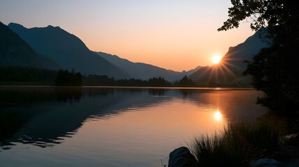 Obraz premium Warm sunset light reflects beautifully off the calm water creating a stunning mountain landscape scene