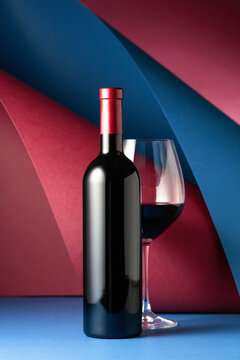 Bottle and glass of red wine.