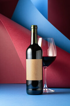 Bottle and glass of red wine.