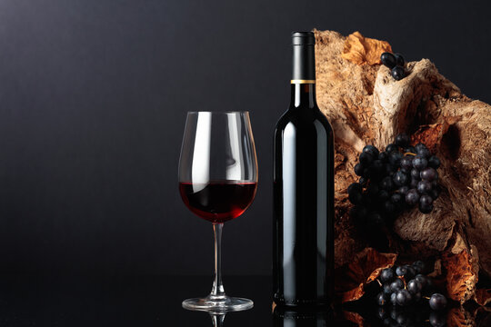 Bottle and glass of red wine.