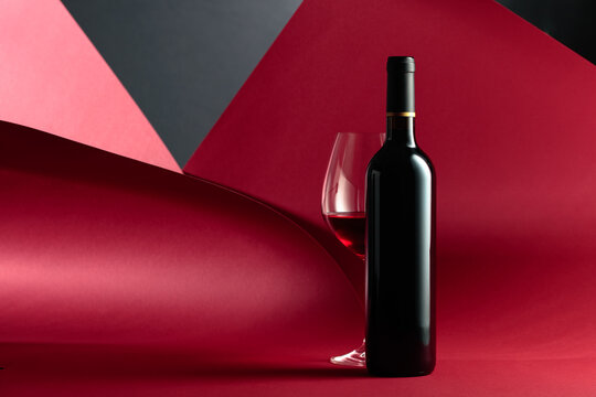 Bottle and glass of red wine.