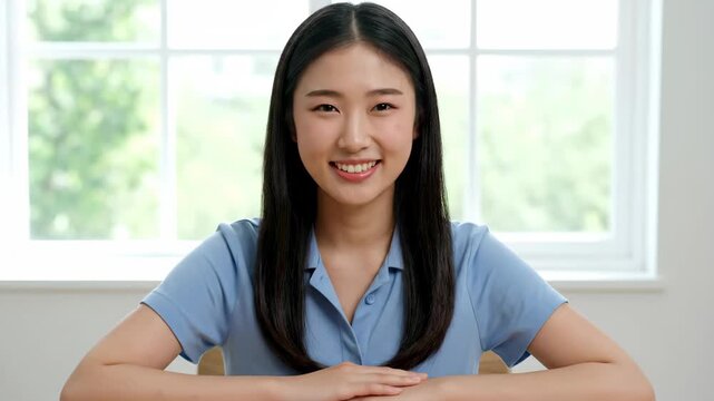 Close-up of a smiling woman indoors, a smiling girl by the window