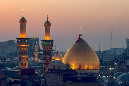 Karbala, Iraq - December 28, 2025: Golden dome and illuminated minarets of the Imam Hussain Shrine glowing at dusk in Karbala, Iraq