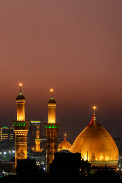 Karbala, Iraq - December 28, 2025: Golden dome and illuminated minarets of the Imam Hussain Shrine glowing at dusk in Karbala, Iraq