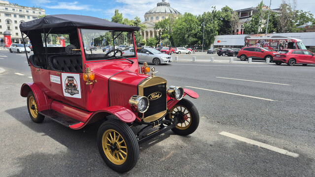 Red vintage Ford Model T replica parked on a city street in Bucharest near the Romanian Athenaeum. Picture taken on May 31, 2026 on Calea Victoriei.