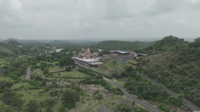 Ancient temple nestled among lush forested hills, surrounded by breathtaking natural landscapes, creating a peaceful and spiritual atmosphere.