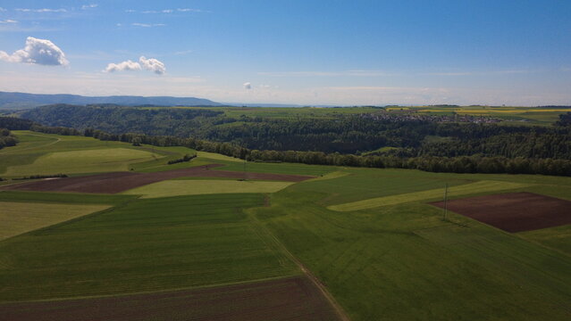 Aerial drone view of farmland fields and rural landscape in spring