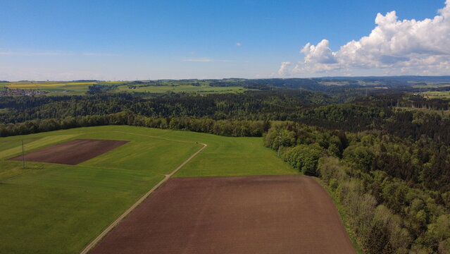 Aerial drone view of farmland fields and rural landscape in spring