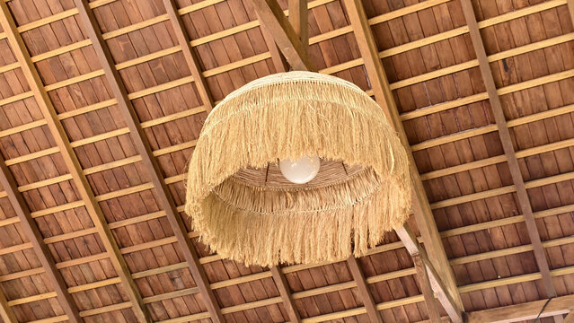 boho style pendant lamp made of natural raffia with a fringed texture
