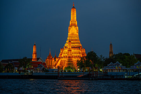 Wat Arun illuminated at twilight in Bangkok