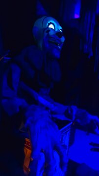 An evil animatronic clown whose face glows in the dark on Halloween.