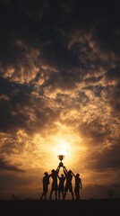 Fototapeta premium Silhouetted team celebrating victory with trophy against dramatic sunset