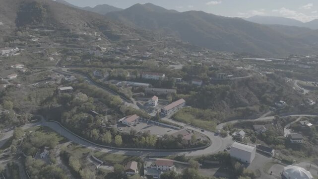 Aerial drone view of a mountain village and hilly landscape with flat log profile, Azerbaijan