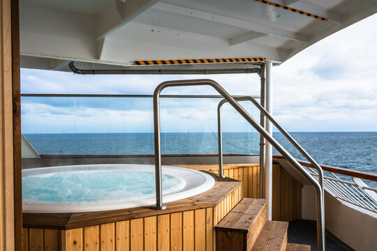 Hot tub on a cruise ship in Norway with views of the ocean on a cloudy day