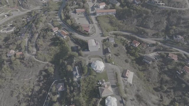 Aerial drone view of a mountain village and hilly landscape with flat log profile, Azerbaijan
