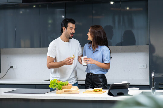 Young couple in love. attractive woman and hansome man cooking at kitchen.