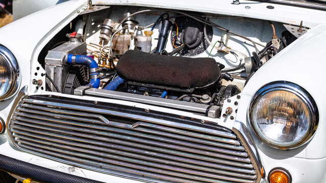 Classic Mini car engine bay open hood showing engine parts 