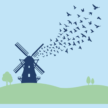 A dark windmill silhouette with a flock of birds flying away