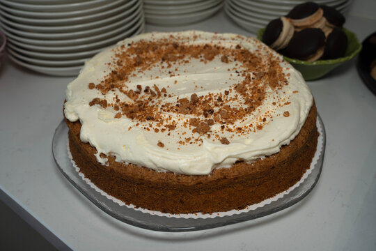 Spiced sponge cake topped with whipped cream cheese and crumble garnish