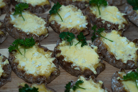 Traditional Finnish Karelian pasties topped with egg butter and fresh parsley