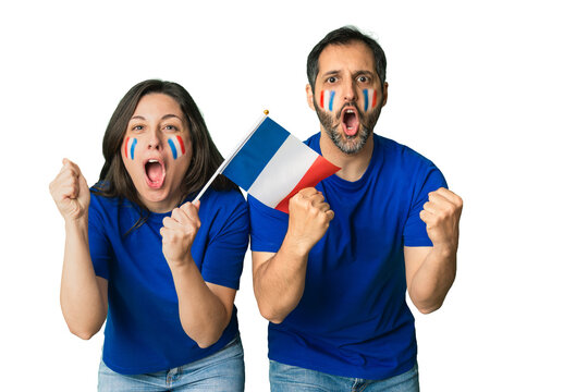 French fans cheering and celebrating success with face paint and national flag