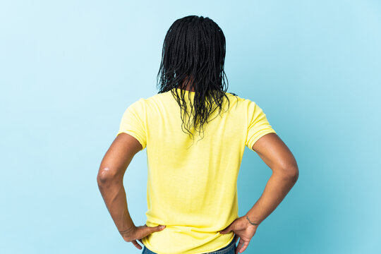 Delivery African American man with braids isolated on white background in back position