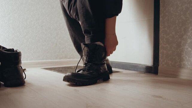 Prepared for adventure. Ready to step into outdoors. Stepping boldly into wilderness with purposeful determination. Dawn breaks as sturdy boots are laced tightly for exploration ahead