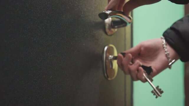 Quiet key insertion. Subtle turning and slipping key. Delicately turning and slipping key into lock without noise. Executing gentle turn and smooth insertion of key into lock with utmost caution