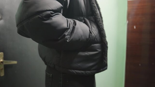 Hand smokes scene. Closeup of smoking hand scene. Intimate shot of cigaretteholding musician in dim corridor. Moment capturing musician holding cigarette amid lowvisibility corridor lighting