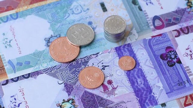 Qatar paper money, the Qatari riyal as a tool for financial transactions and trade. Qatari money as a business background for your design