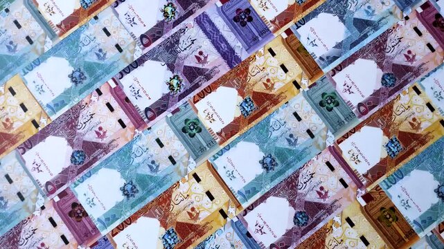 Qatar paper money, the Qatari riyal as a tool for financial transactions and trade. Qatari money as a business background for your design