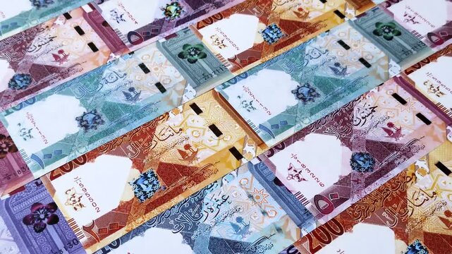 Qatar paper money, the Qatari riyal as a tool for financial transactions and trade. Qatari money as a business background for your design