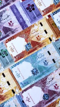 Qatar paper money, the Qatari riyal as a tool for financial transactions and trade. Qatari money as a business background for your design